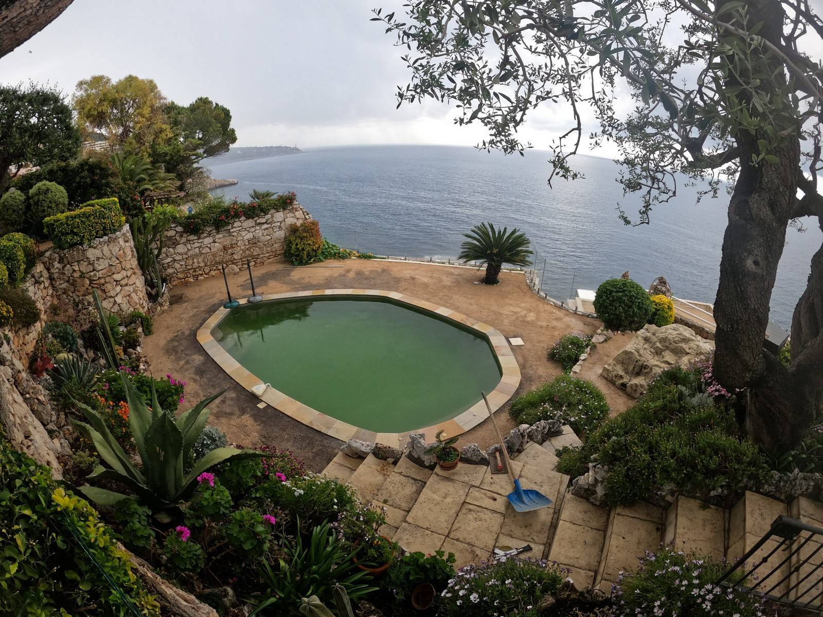 Pose d'un contour de piscine en pelouse synthétique de luxe à flanc de falaise avec vue sur la mer Méditerranée à Nice